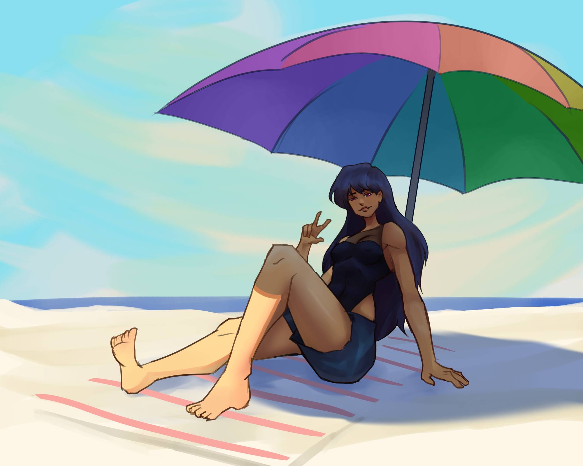 Woman sitting on a beach under a rainbow umbrella